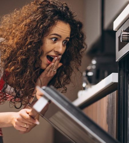 Woman baking meal in the oven